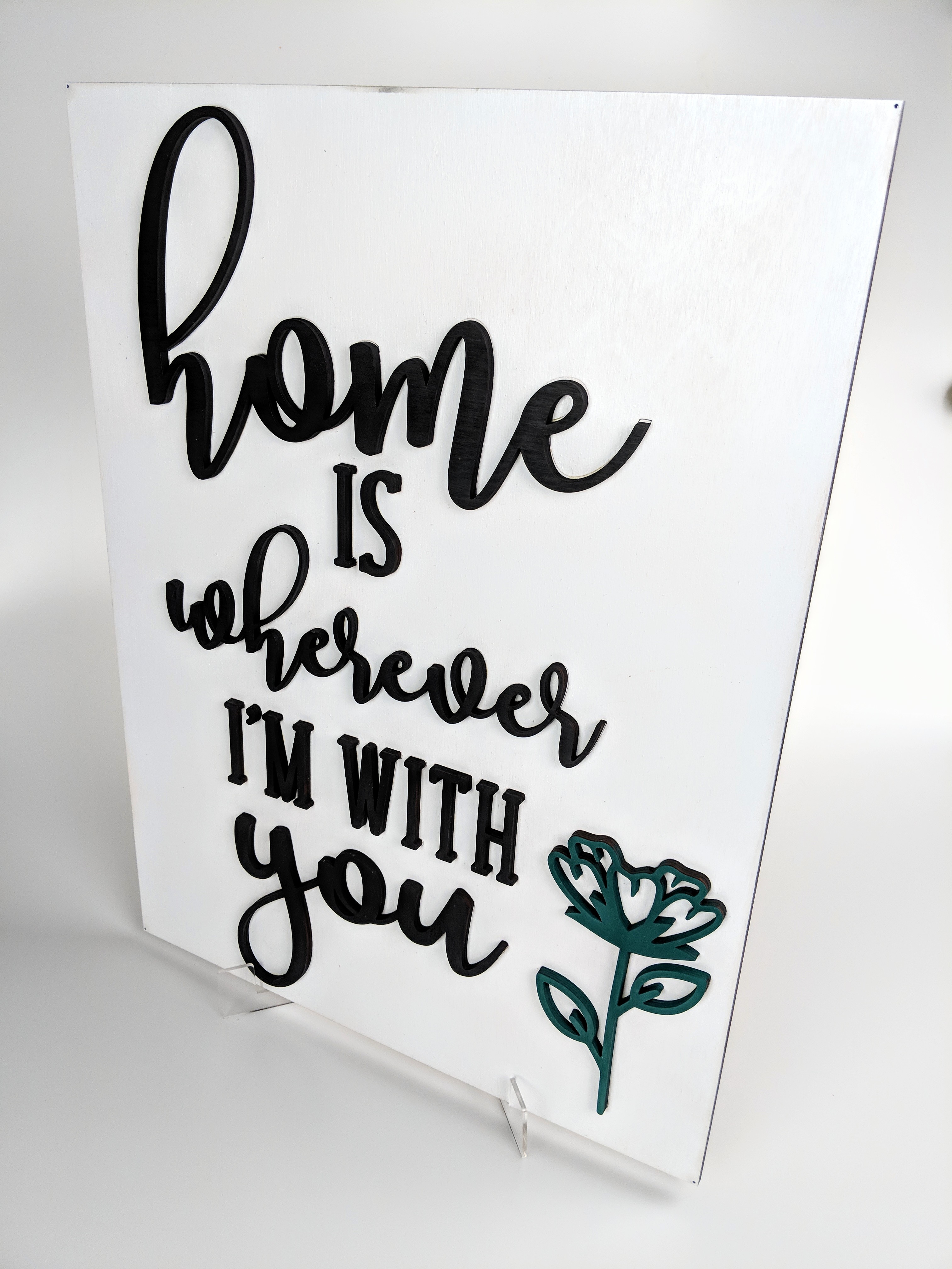 Wooden Sign with white background that reads "Home is Wherever I'm With You" with teal flower
